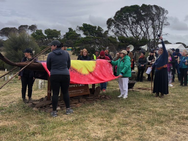 Timme's canoe ceremony with aboriginal flag