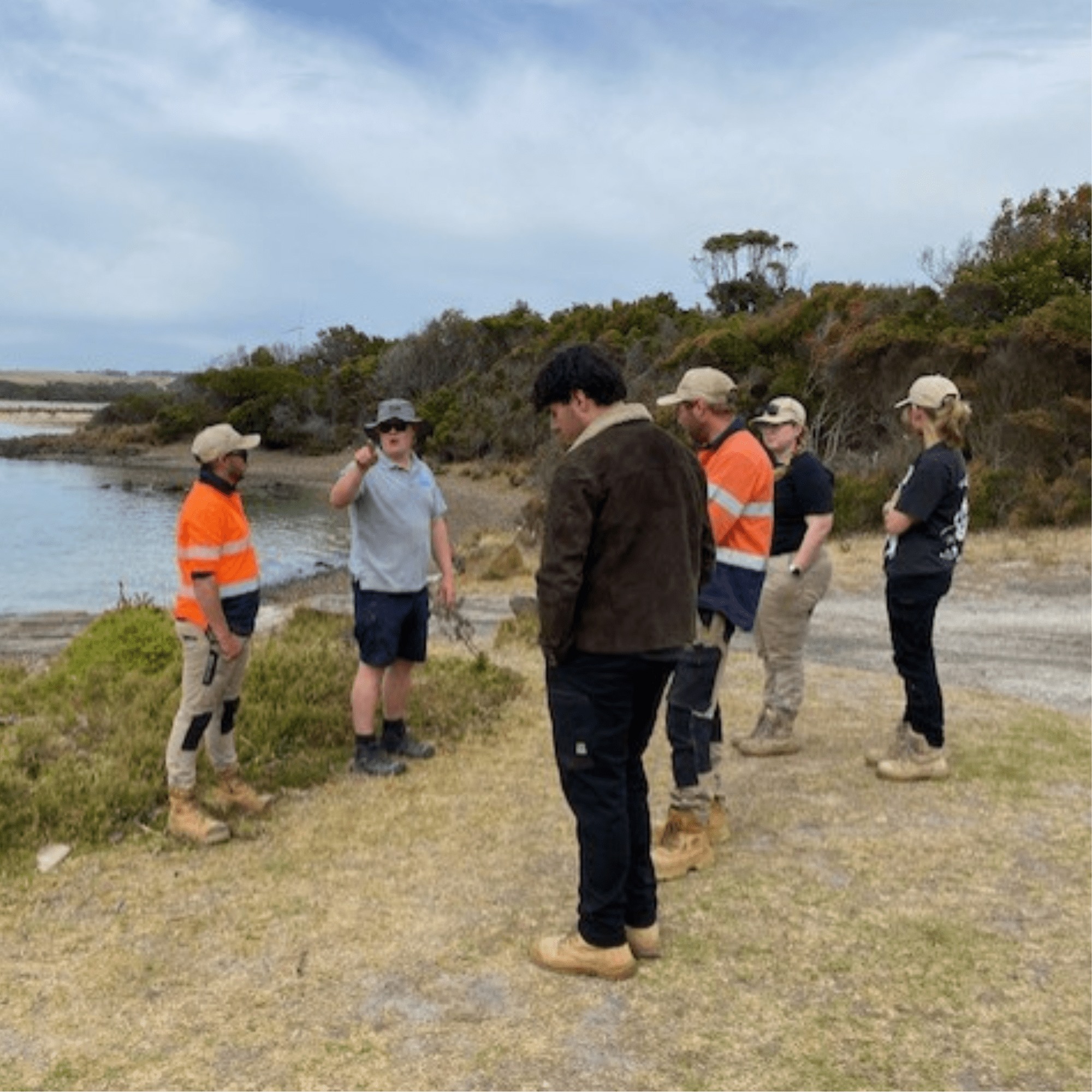 Consultation Aboriginal ranger with fire hose conducting cultural burning for land management